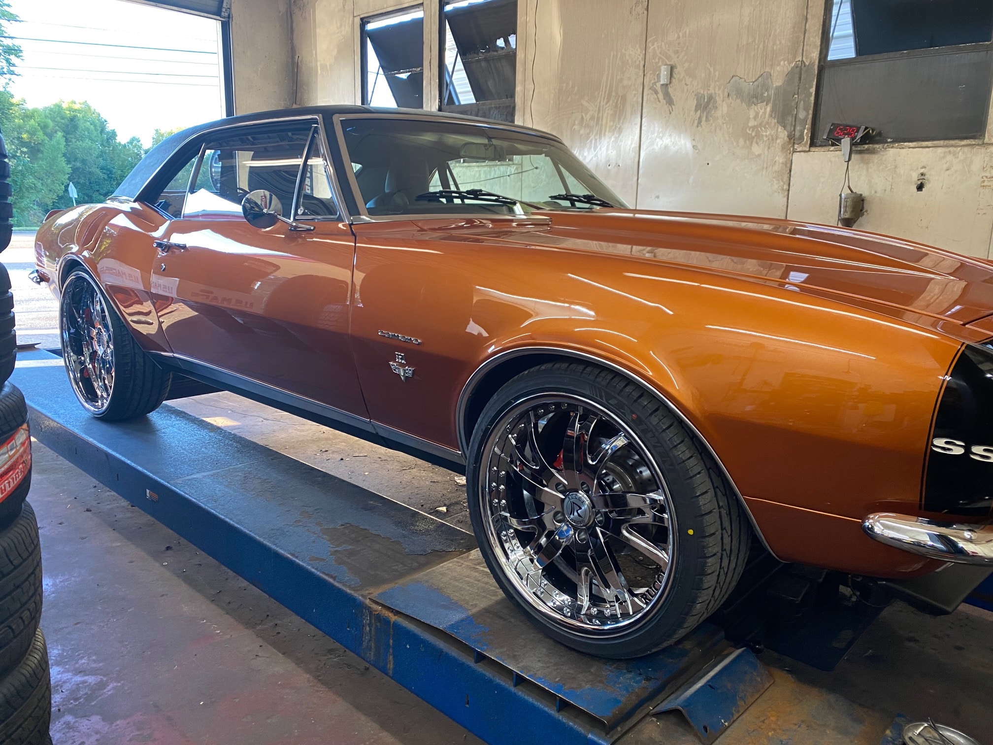 Car on hydraulic lift for tire rotation
